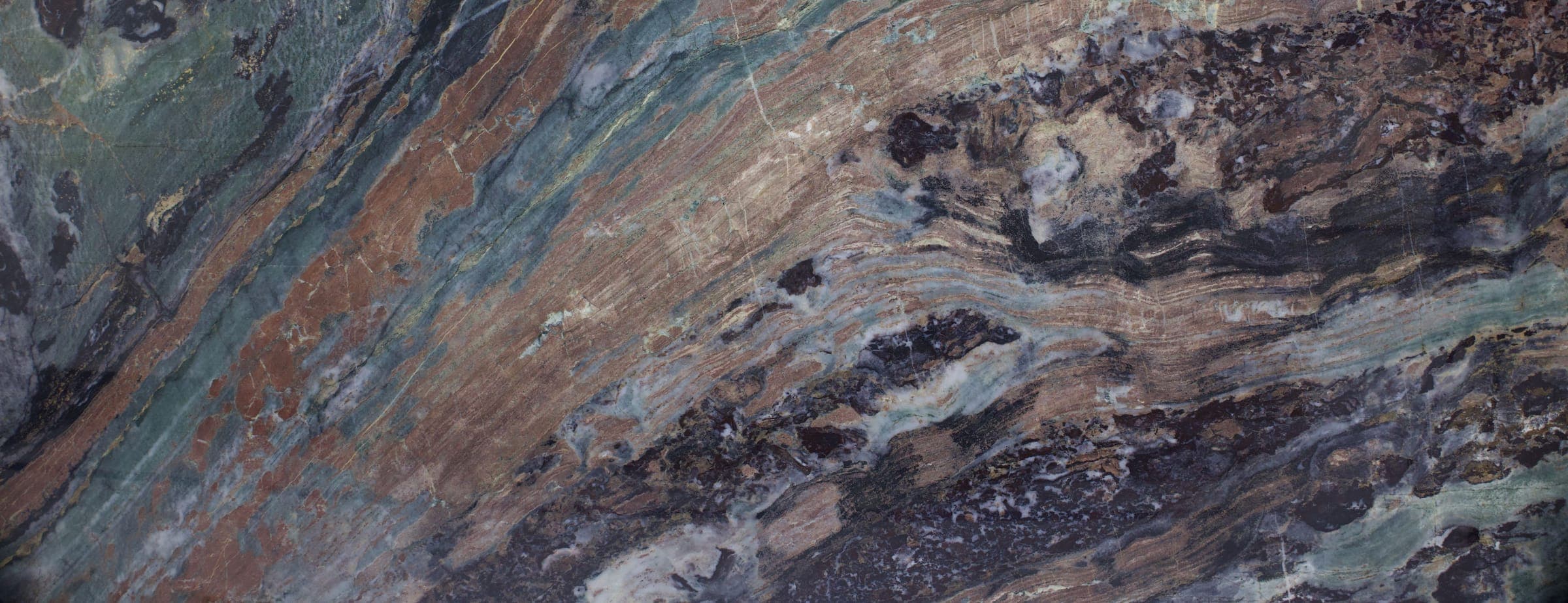 Close-up of a stone slab with rust, green, and deep purple veining